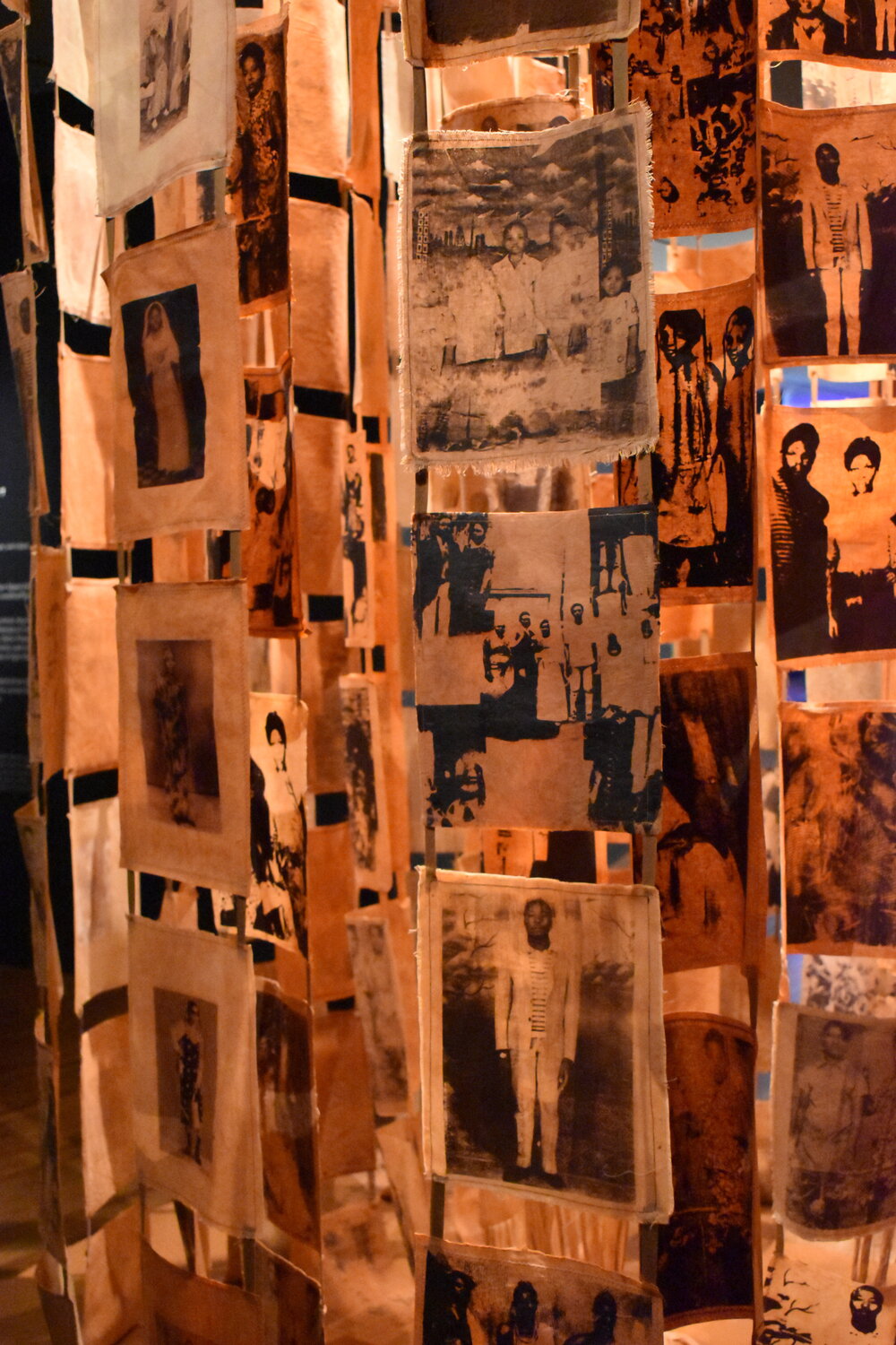 Mallory Lowe Mpoka, The Matriarch: Unraveled Threads, 2021-2024. Analog photography, screen printing, photo transfer, embroidery on dyed cotton and linen with red earth pigments, acrylic, paper, and steel. Courtesy of the artist. Photography Credit: Rory Kearney-Fick.